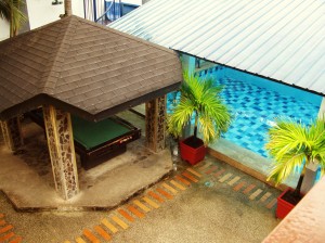 A view of the billiards table and swimming pool from the main house.